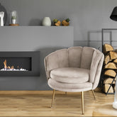 Sillón redondo de terciopelo topo con patas de metal dorado
