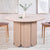Mesa redonda extensible japandi de 310cm Cavelna con extensiones integradas de madera clara