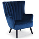 Sillón de terciopelo azul con respaldo acolchado